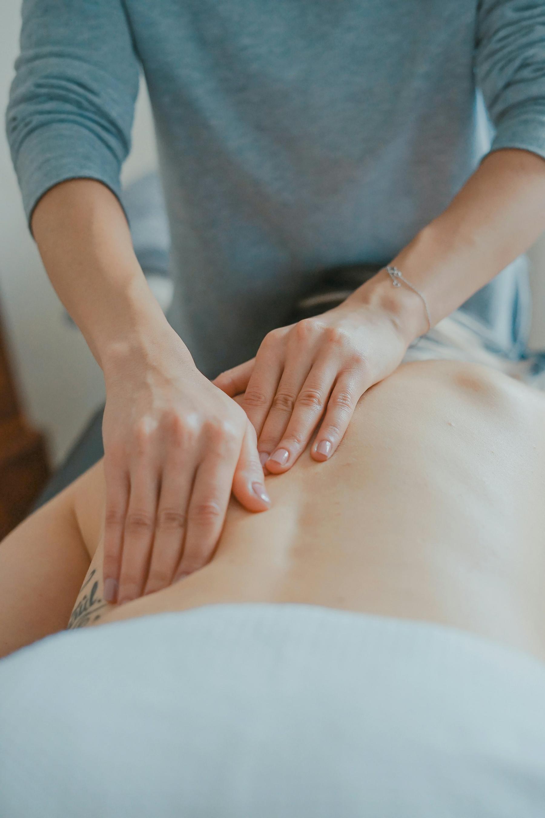Therapist delivering precise hands-on shoulder treatment at Body Tune Up